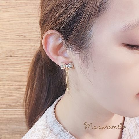 【焦糖小姐 Ms caramelo】夾式 貝珠+蝴蝶結流蘇鋯石耳環