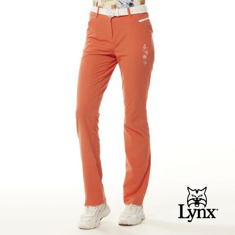 Lynx Golf 女款彈性舒適Lynx魔術方塊繡花拉鍊口袋配色透氣織帶剪接造型窄管長褲-橘色