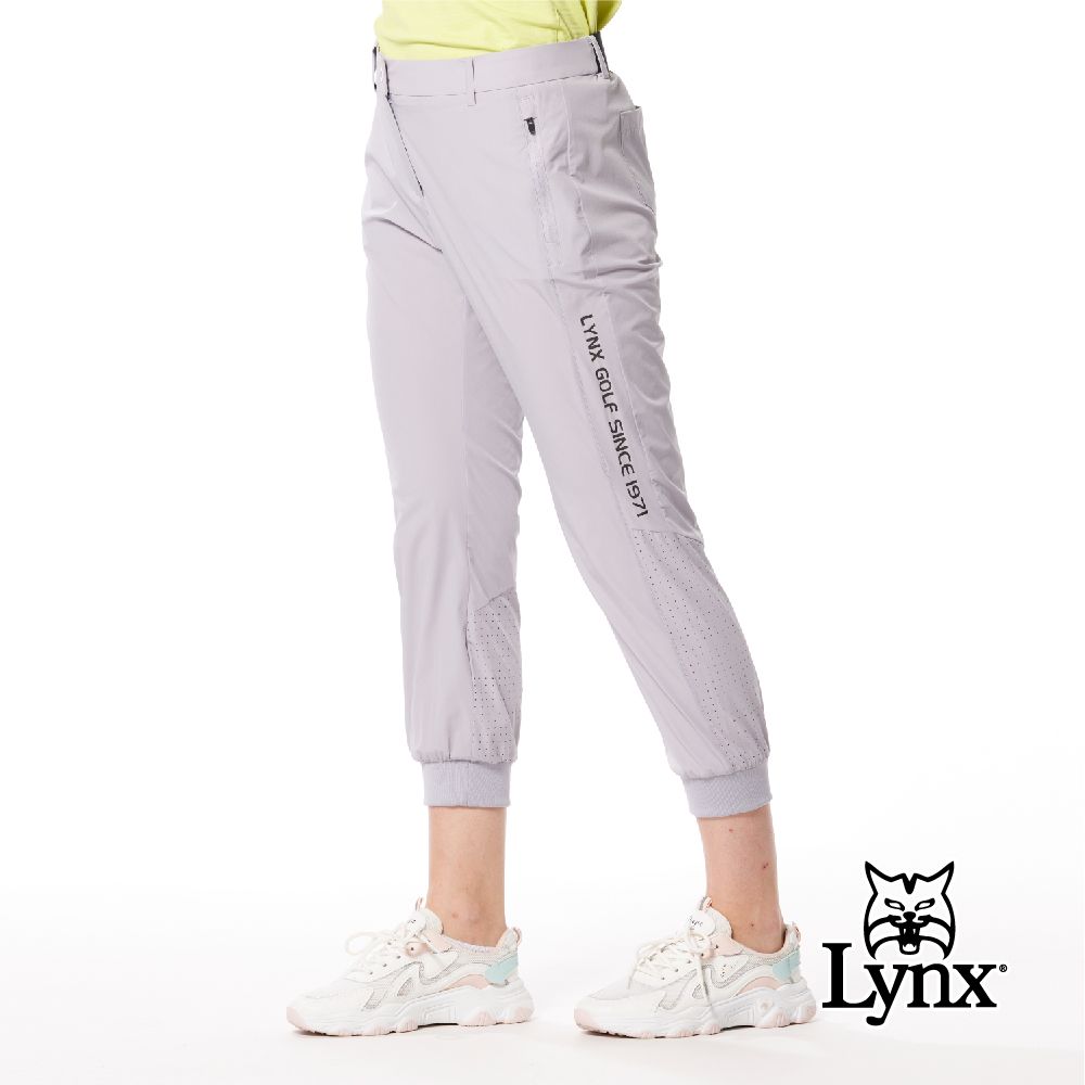 Lynx Golf 首爾高桿風格女款彈性舒適素面LOGO織帶剪接設計拉鍊口袋羅紋縮口窄管九分褲(二色)