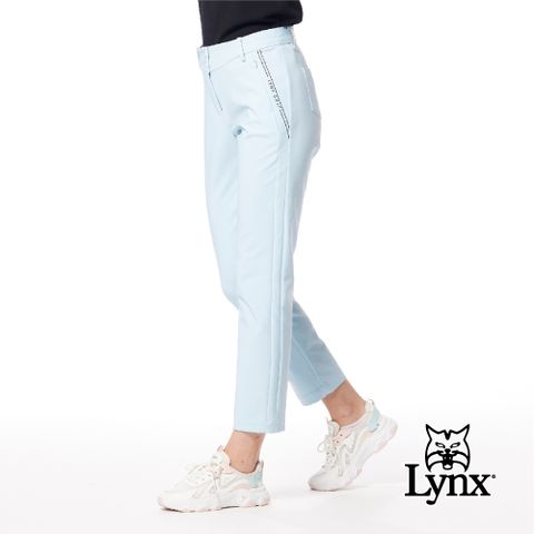 Lynx Golf 女款彈性舒適腰頭造型兩側脇邊剪裁LOGO膠印隱形拉鍊口袋窄管九分褲-冰藍色